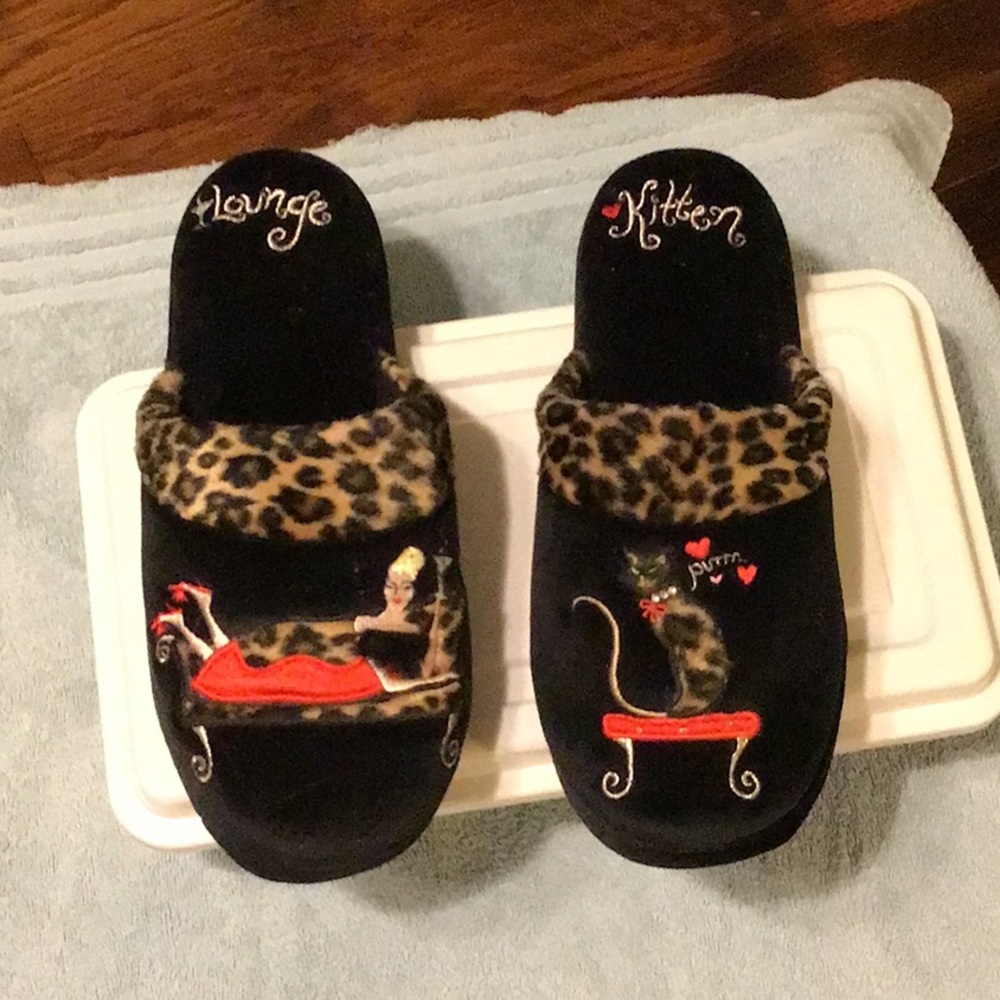 Black Slippers with lots of detailing.